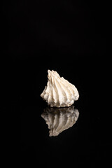 Meringue baiser. .Airy French dessert isolated on a dark background.