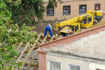 Workers roofers builders working on roof structure on construction site