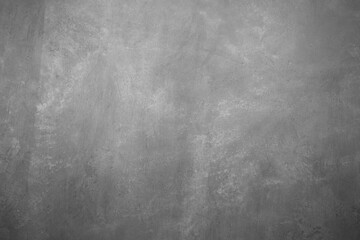 The texture of the gray plaster wall with scratches and cracks.