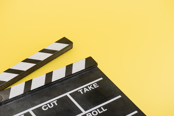 Fototapeta na wymiar close up view of clapperboard on yellow background, cinema concept