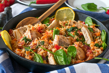 Fish with rice and vegetable in a pan