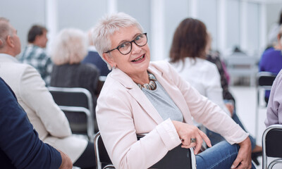 Woman at presentation looks at camera