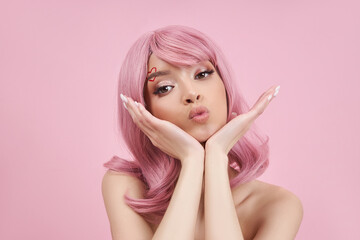 Portrait sexy young woman with pink hair. Perfect hairstyle and hair coloring. Girl with beautiful eyes and long pink hair