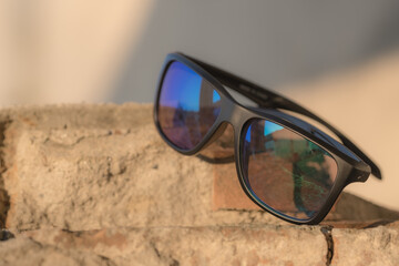 Classic Sunglasses model shoot in a urban place in a summer day. Selective focus. High quality photo