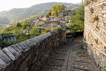 Stone houses of traditional architecture and cobble-stone narrow street in Mikro Papigo in Epirus, Greece