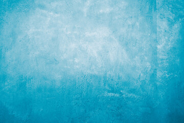 The blue cement wall had some scratches and cracks.