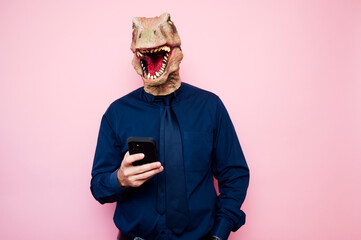 man in dinosaur mask using smartphone