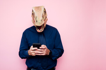 man in dinosaur mask using smartphone