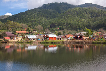 Fototapeta na wymiar Ban Rak Thai, A highland village set in a valley surrounded by hills and tea plantations on the edge of a reservoir in Mea Hong Son Province, Thailand