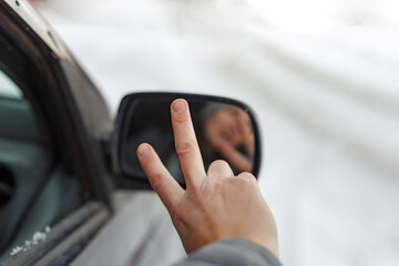 Reflection of a female&lsquo;s face in the car mirror