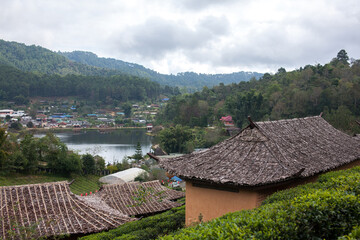 Fototapeta na wymiar Ban Rak Thai, A highland village set in a valley surrounded by hills and tea plantations on the edge of a reservoir in Mea Hong Son Province, Thailand