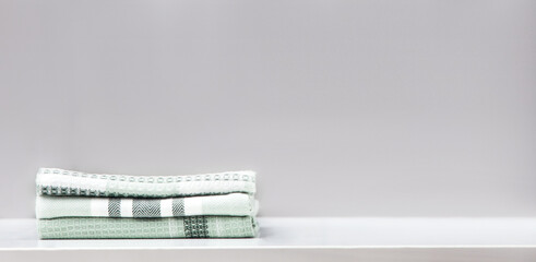 Stack of cotton kitchen towels on table