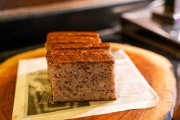 Slices of banana cake on wooden plate.