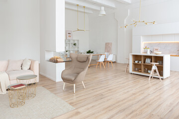 interior design spacious bright studio apartment in Scandinavian style and warm pastel white and beige colors. trendy furniture in the living area and modern details in the kitchen area.
