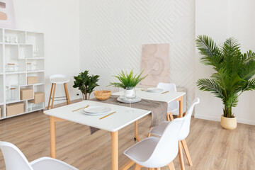 interior design spacious bright studio apartment in Scandinavian style and warm pastel white and beige colors. trendy furniture in the living area and modern details in the kitchen area.