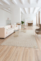 interior design spacious bright studio apartment in Scandinavian style and warm pastel white and beige colors. trendy furniture in the living area and modern details in the kitchen area.