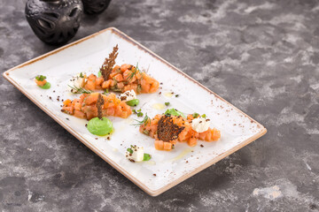 Raw salmon tartare steak with wasabi on the table