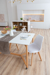 interior design spacious bright studio apartment in Scandinavian style and warm pastel white and beige colors. trendy furniture in the living area and modern details in the kitchen area.