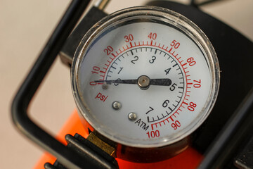 Car compressor pressure gauge scale on a light background.