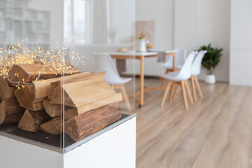 interior design spacious bright studio apartment in Scandinavian style and warm pastel white and beige colors. trendy furniture in the living area and modern details in the kitchen area.