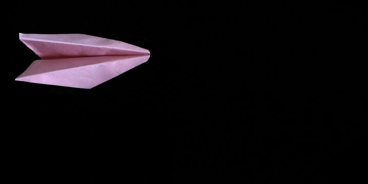 Pink Paper Airplane On Black Background