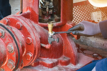 maintenance man check height temperature of motor fire pump in the factory