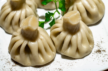 Khinkali, Georgian dumplings, traditional Georgian cuisine. Khinkali on a plate side view