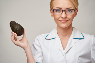 nutritionist doctor healthy lifestyle concept - holding organic avocado fruit