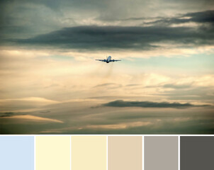 Color palette swatches of dramatic dark grey and bright orange clouds in the sky at sunset, a small...