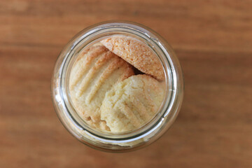 glass Jar with homemade cookies on light background