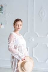 Obraz premium portrait of a pregnant woman in a white dress