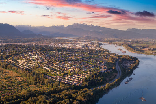 Aerial view of residential neighborhood in Port Coquitlam. Colorful sunset Sky Art Render. Taken in Vancouver, BC, Canada.