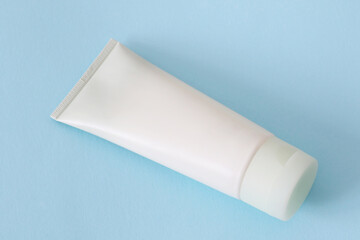 blank cosmetic tube mockup on blue background