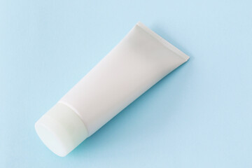 blank cosmetic tube mockup on blue background