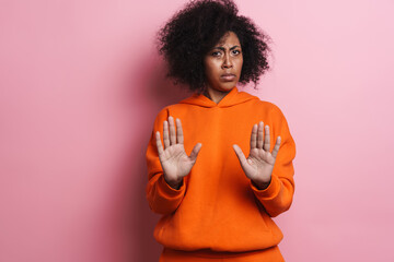 Displeased african american girl showing stop gesture