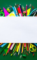 A set of stationery on the background of the chalk board. Back to school concept banner. A large number of pencils, rulers, clips, markers, creatively decomposed with copy space for text.
