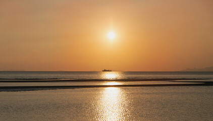 Pastel color of Sky background and Sea beach in morning time,reflection of sunrise shining around