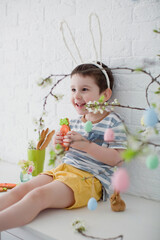 Boy with bunny ears eat cookies