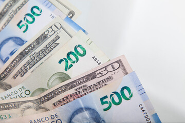 US dollar and mexican pesos on white background, foreign exchange