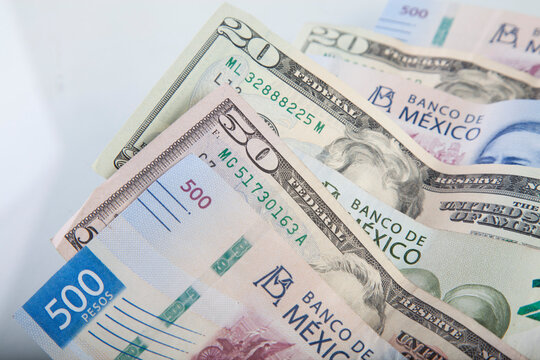 US dollar and mexican pesos on white background, foreign exchange