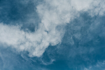 Reflections warm rays setting sun, swirls strong gust wind, outdoors. Bright blue sky, white translucent feathery clouds. Horizontal photography
