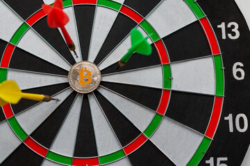 Bitcoin cryptocurrency in the center of darts