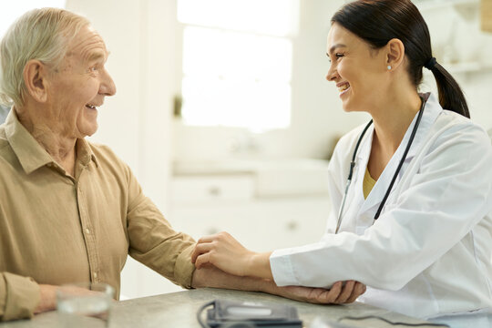 Friendly Doctor Getting Along Well With Her Elderly Patient