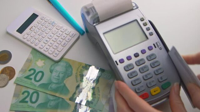 A caucasian woman's hand swipes a card into a debit machine. The screen says "APPROVED". Check out this seller's other videos for "DECLINED" transactions. (Camera Used: Canon C300)