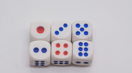 White game cubics with blue and red spikes (dots) on a white background. Game, gambling, chance and risk concept