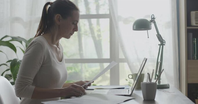 Young businesswoman working from home with her laptop