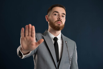 Upset young businessman saying stop