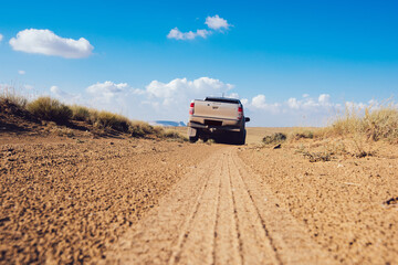 Pickup truck driving through countryside road