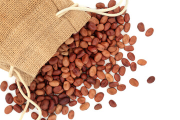 Organic healthy fava beans, broad beans, in a hessian sack & loose on white. Vegan & vegetarian...