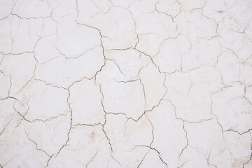 Damaged cracks on white sandy surface